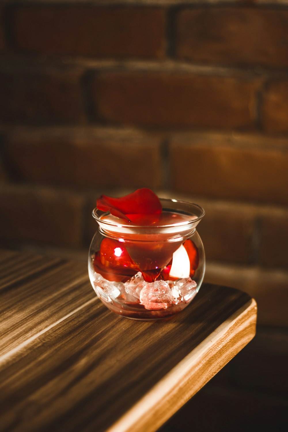 full glass vase on edge of table