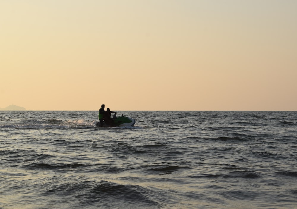 two people riding pesonal watercraft