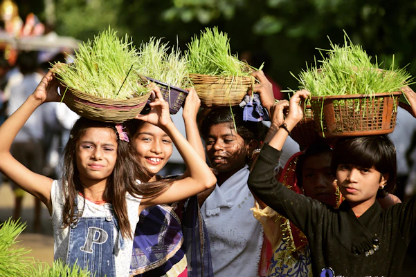 selective focus of group of people carrying grasses