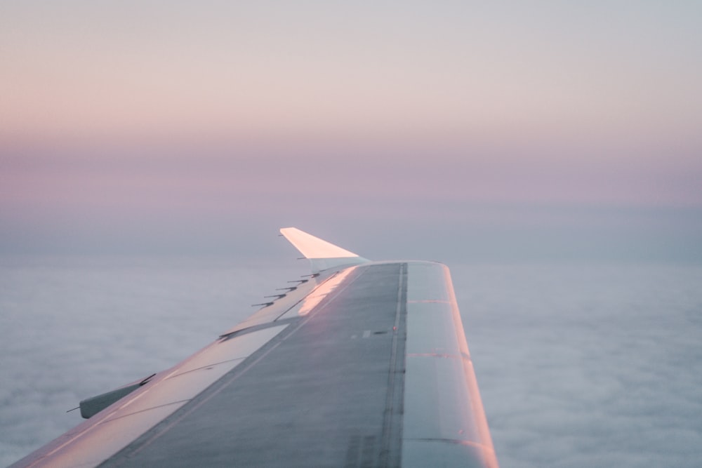 airplane in mid air above clouds during day