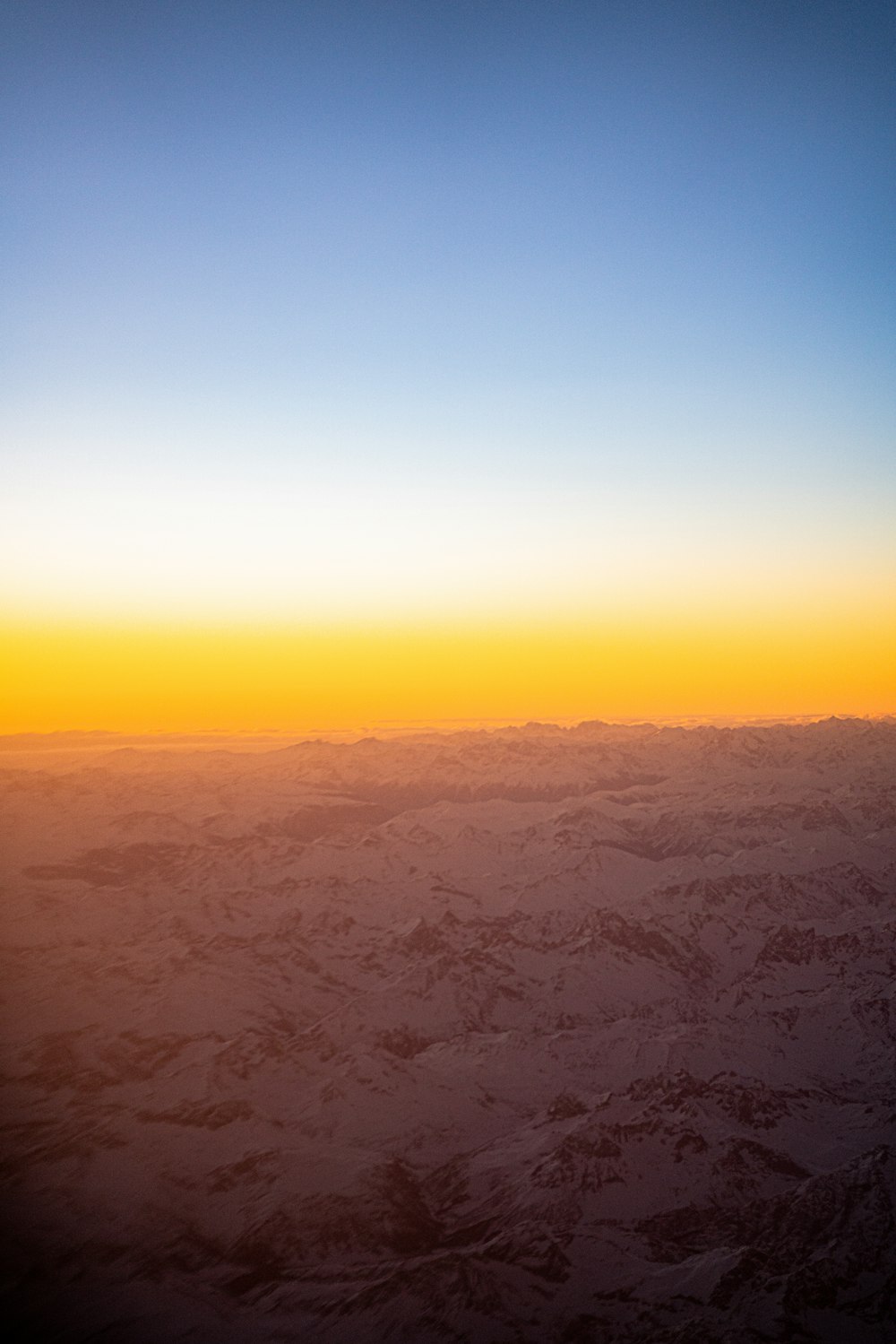 낮에 눈으로 덮인 산의 항공 사진
