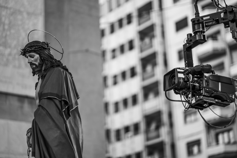 video camera near Jesus Christ statue near buildings