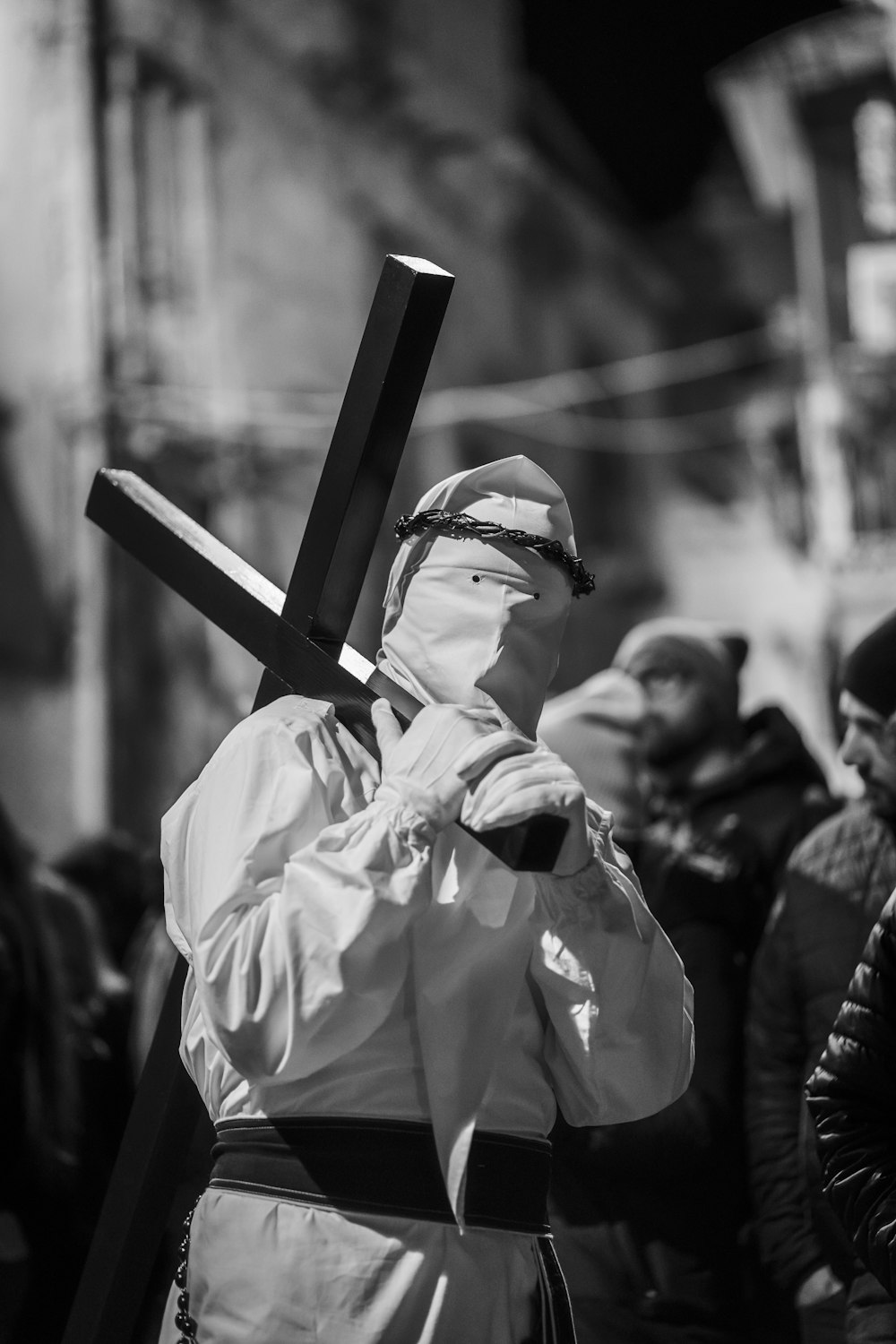 man carrying cross on their shoulder