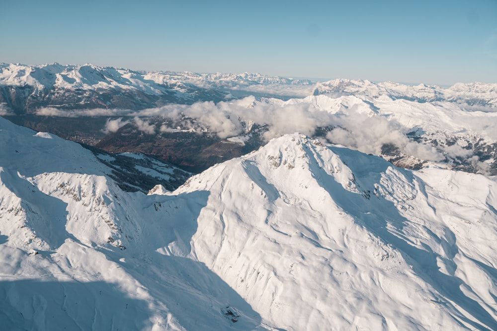 landscape photography of mountain covered with snow under blue and white sky