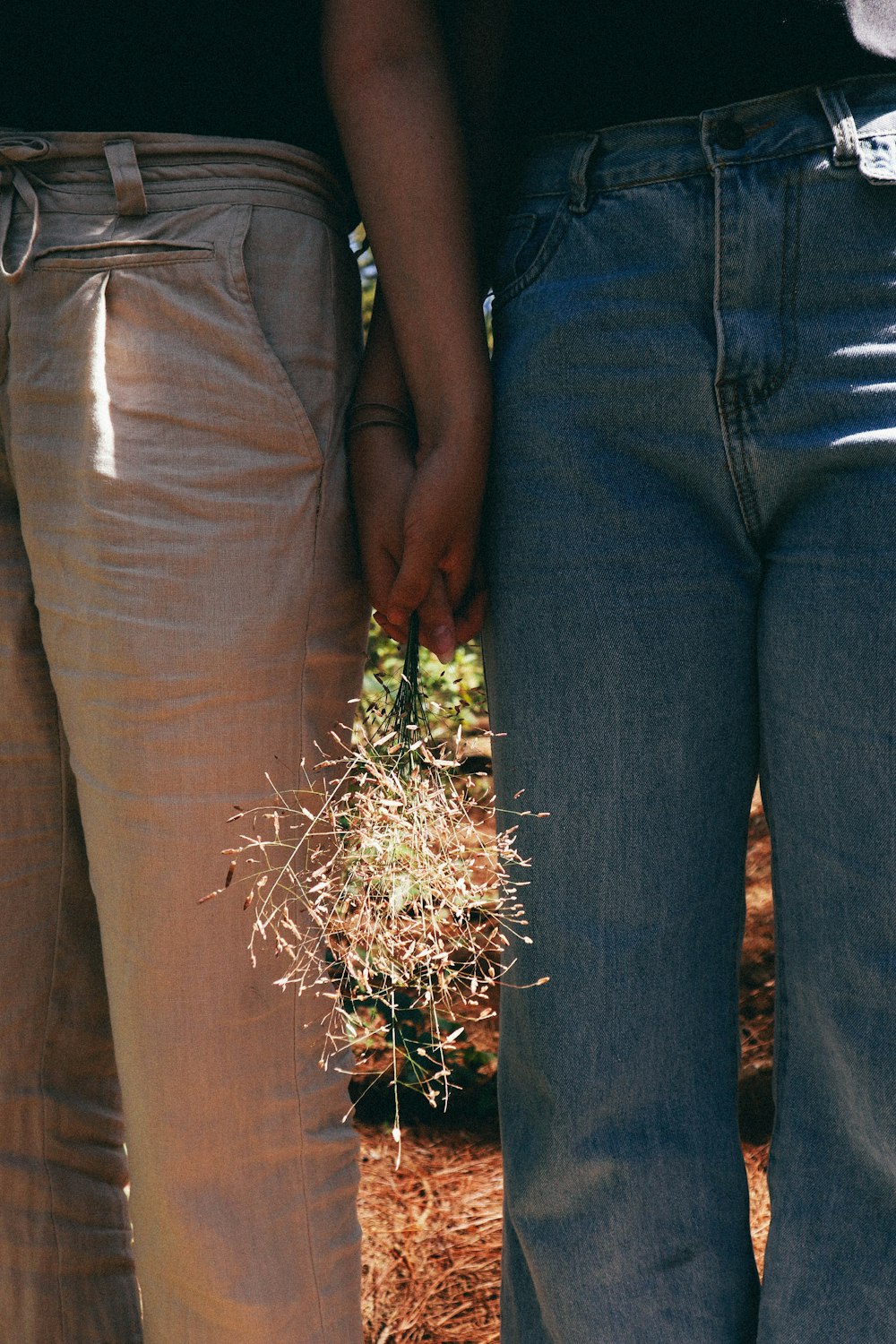 two people holding hands and flower