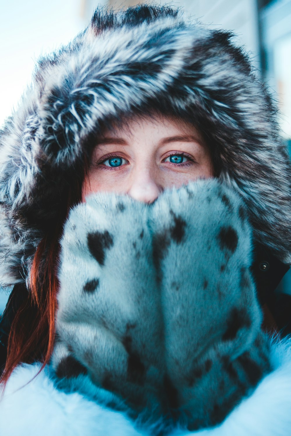 woman wearing white and black fur coat and gloves