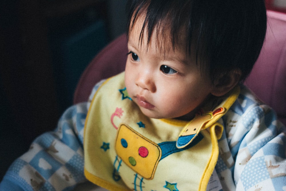 baby wearing yellow bib