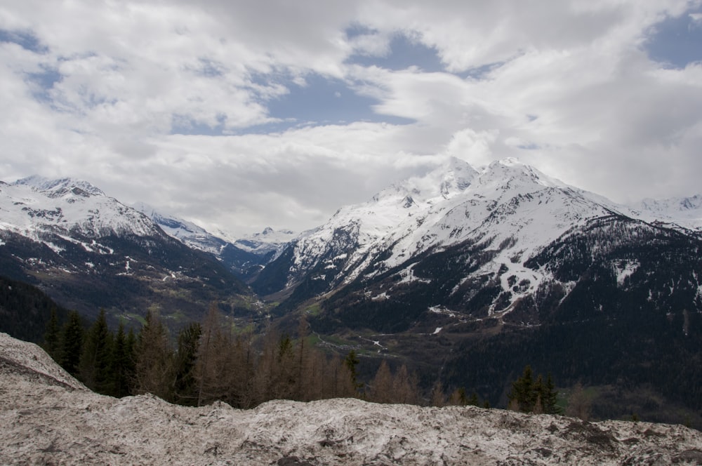 landscape photography of summit of mountain covered with snow under white and blue sky