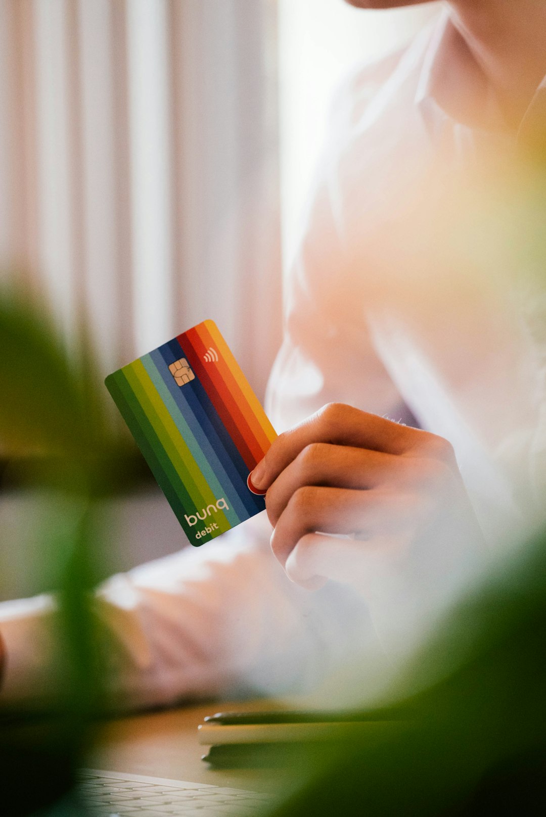 selective focus photography of person holding SIM card