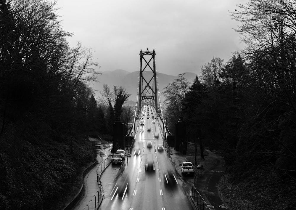 grayscale photography of different vehicles on Lions gate bridge viewing mountain