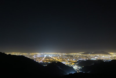 A panoramic view of a city skyline at night.