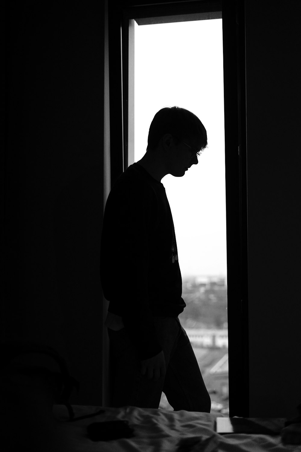 silhouette photography of man near window