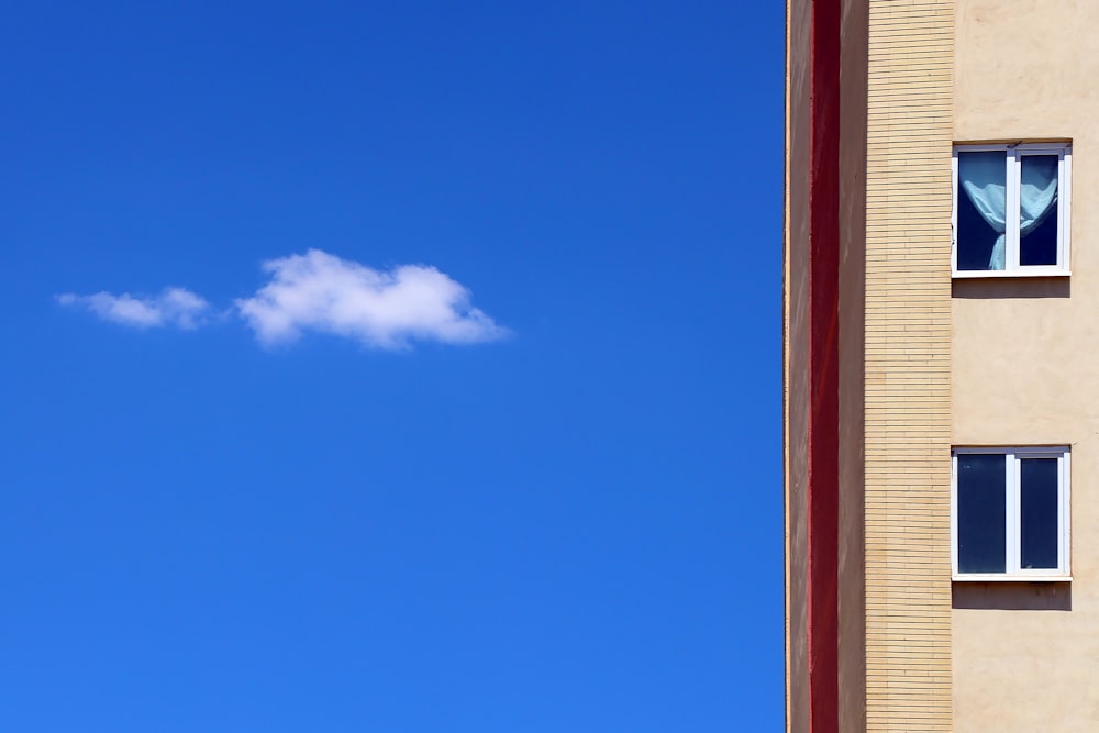 a white cloud floating in a blue sky