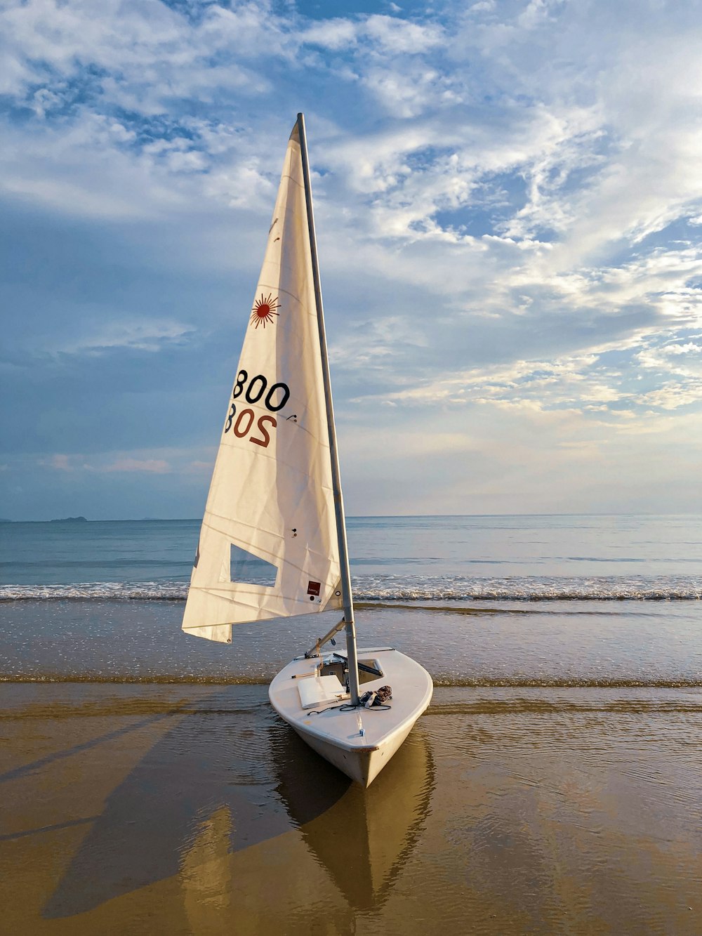 white sailboat on seashore during day