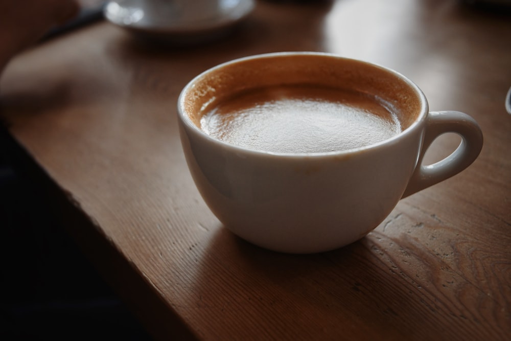 selective focus photography of cup of coffee