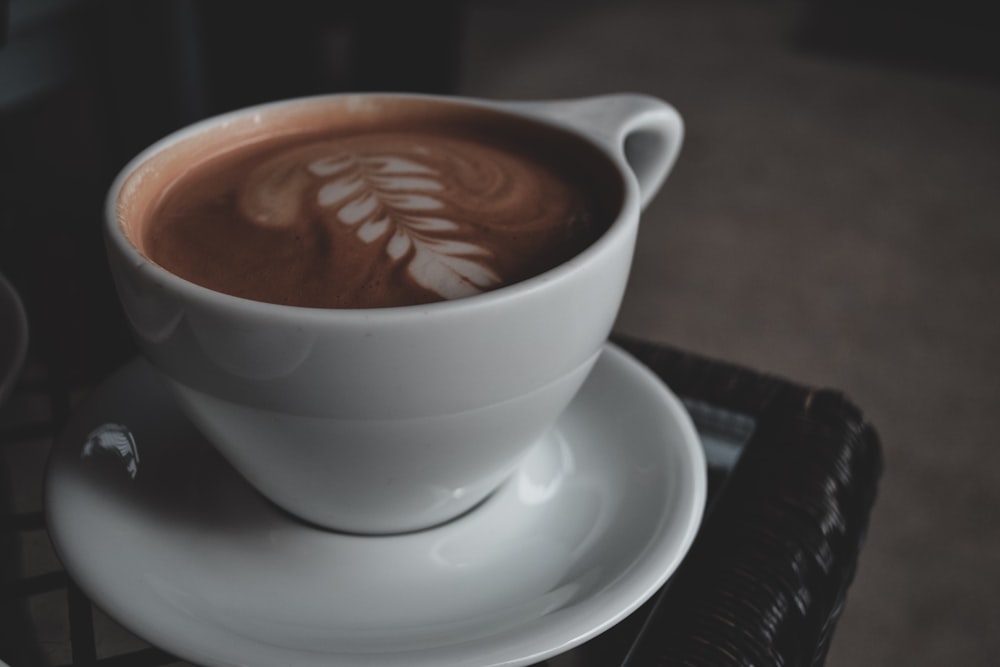 food photography of white ceramic mug with brown liquid