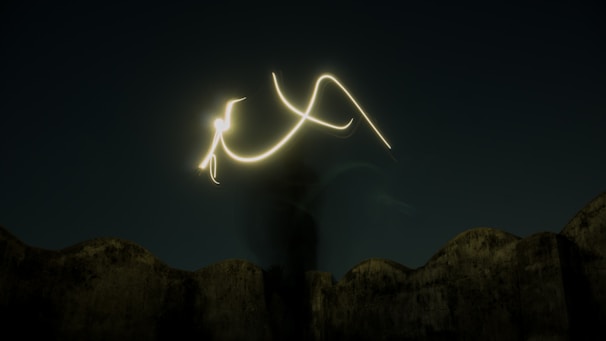 A long exposure photograph captures abstract light trails in a dark night sky. The light forms distinct and flowing patterns resembling calligraphy or abstract art, set against a silhouette of a wave-like stone structure.