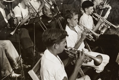 grayscale photography of group of people playing instruments west virginia teams background