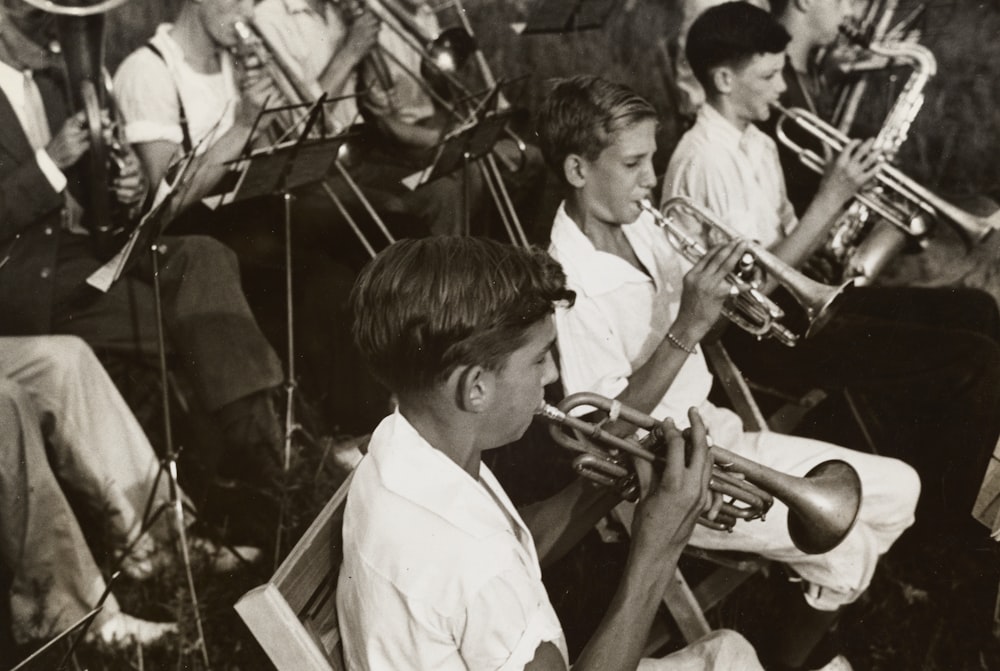 grayscale photography of group of people playing instruments