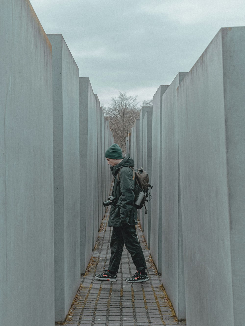 a person with a backpack walking through a cement structure