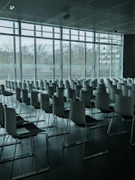 Wide shot of a conference room with automated lighting and window blinds adjusting automatically.