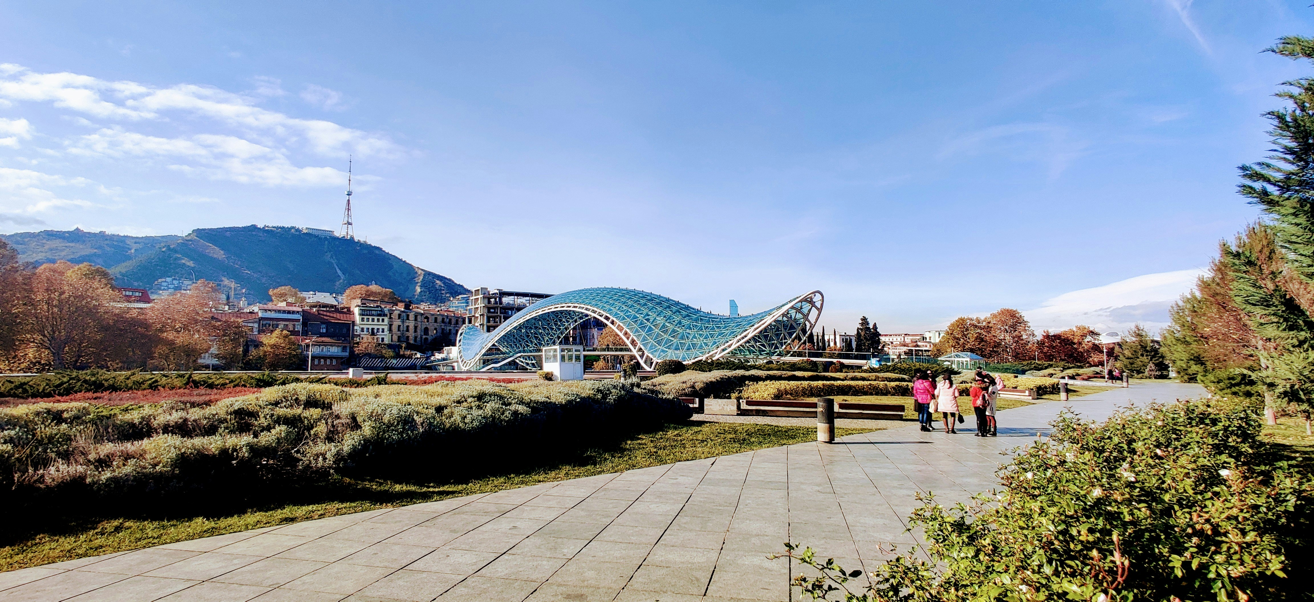 two people walking on a path near a park, Rike park