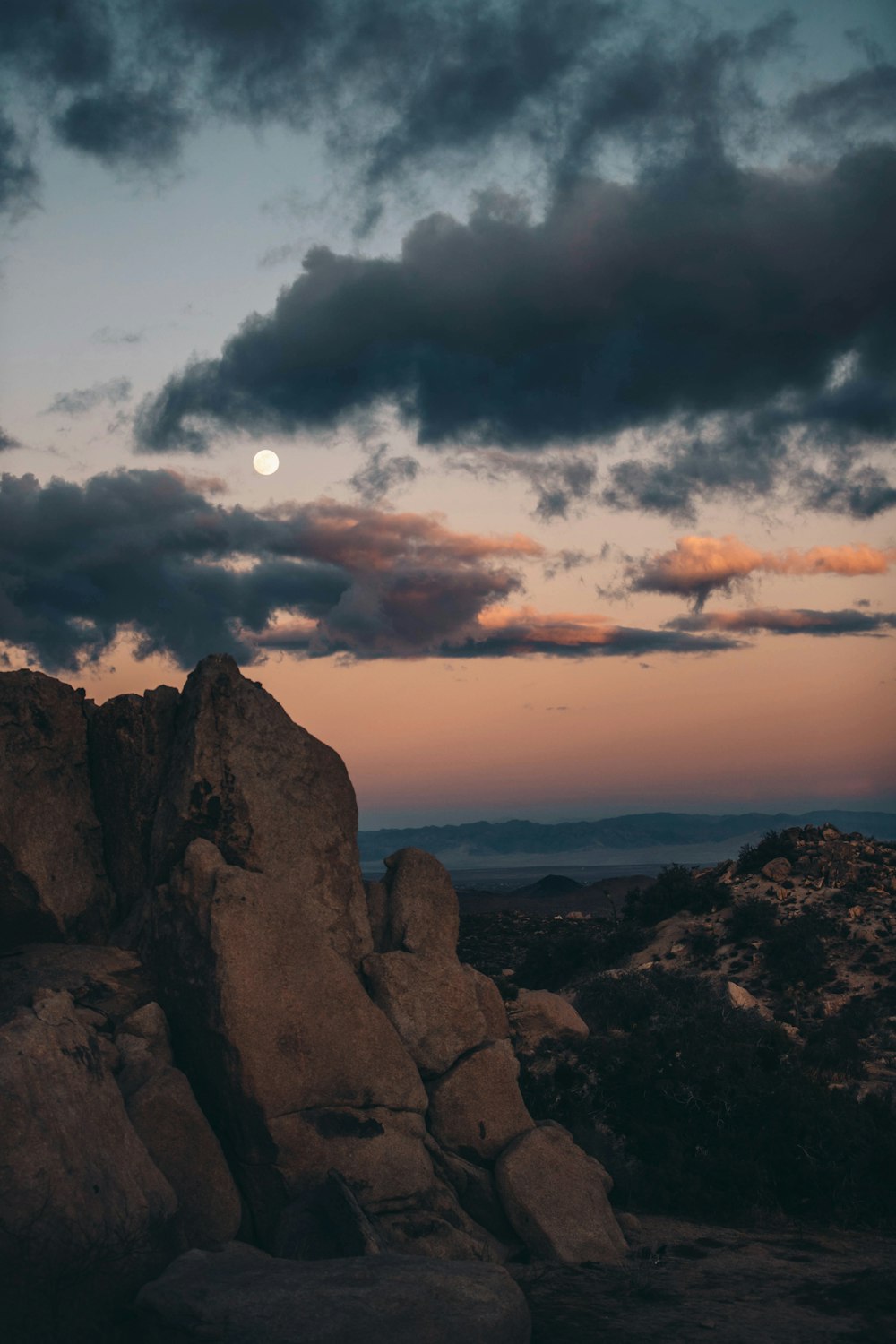 landscape photography of cliff viewing mountain under gray sky