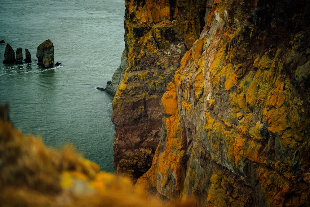 landscape photography of rock formations on body of water during daytime