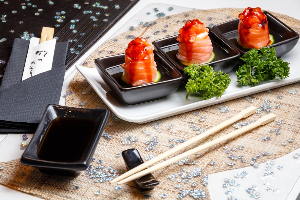 sashimi with parsley on a plate near wooden chopsticks