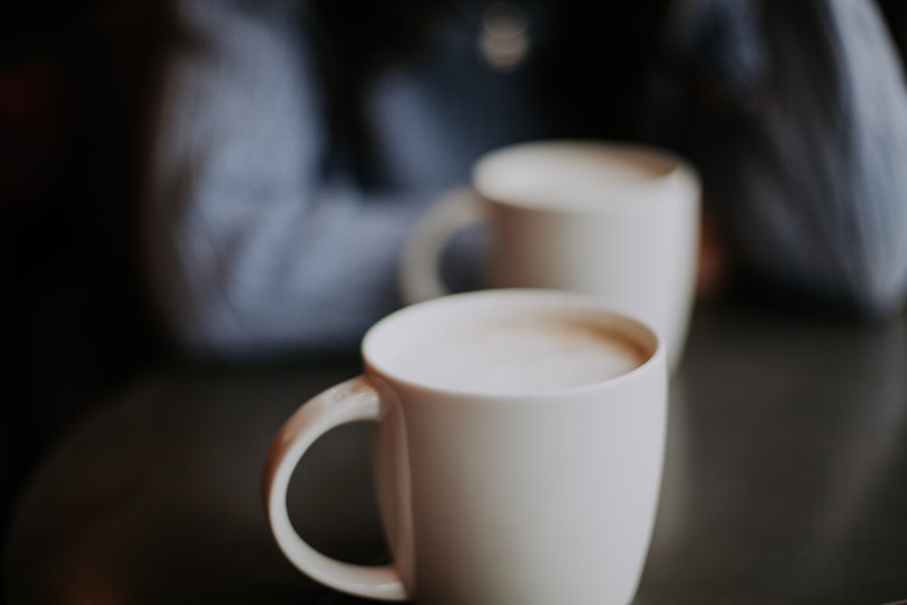 two cappuccino in white mugs