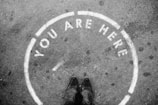 person wearing black leather shoes