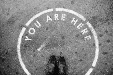 person wearing black leather shoes