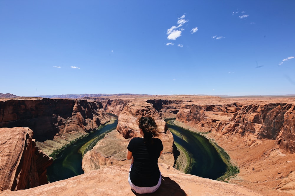 woman sitting on cliff