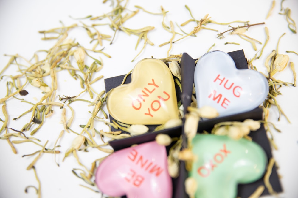 selective focus photography of texts on heart ornaments