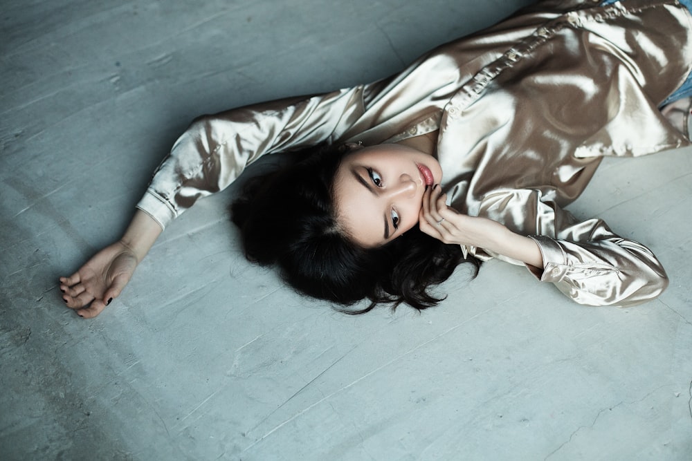 woman in gray pajama top lying down in bed