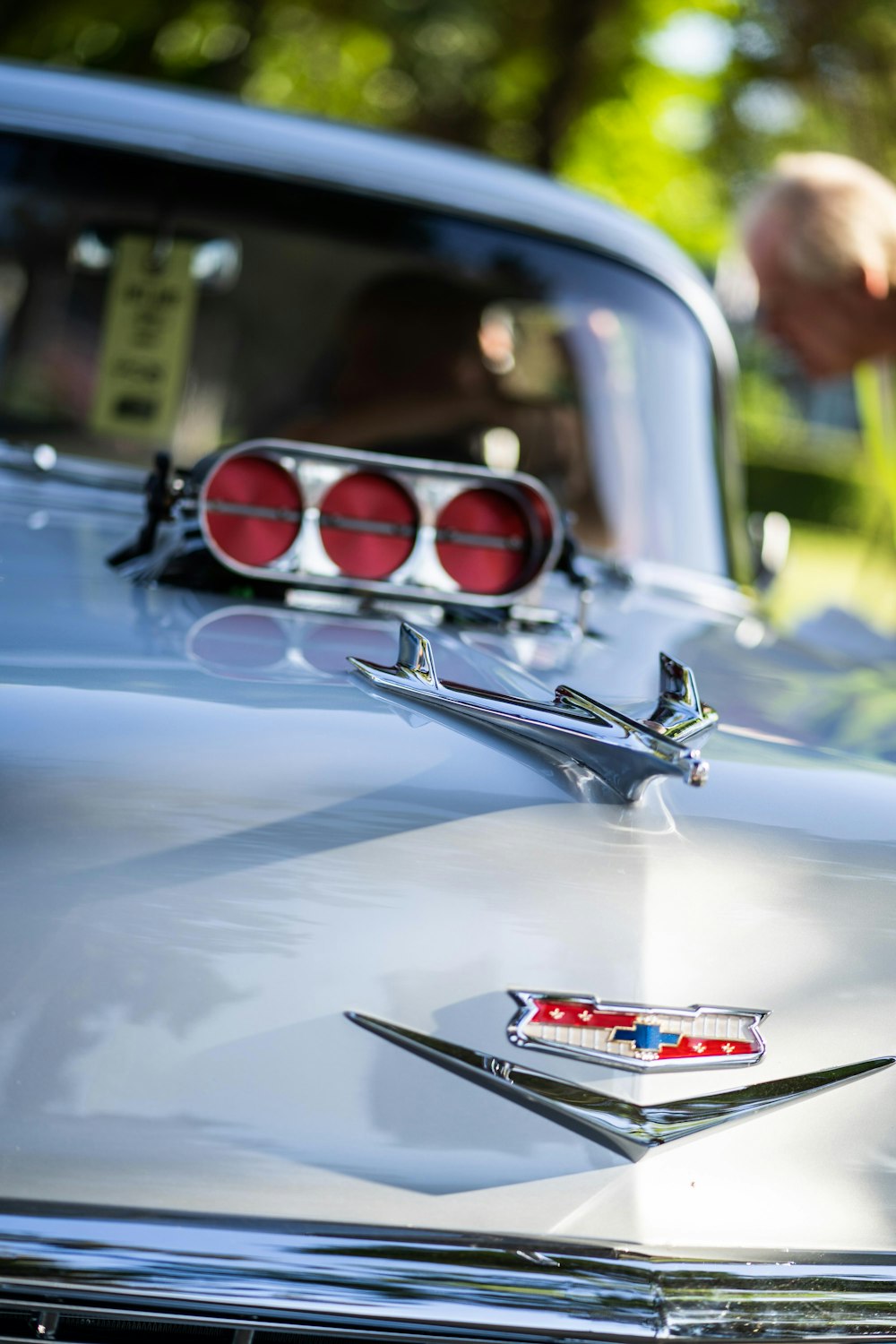 gray V hood emblem during daytime