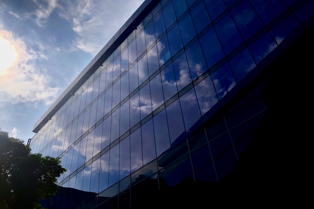 curtain wall building under cloudy sky during daytime