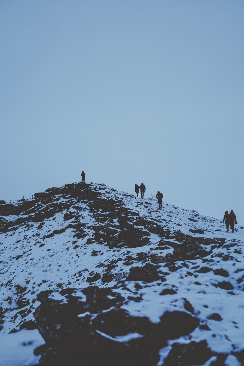 silhouette of people on top of mountain