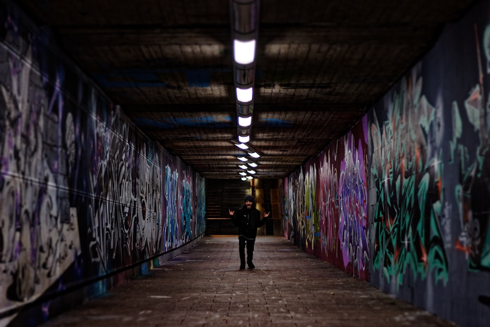 man standing in the middle of walkway