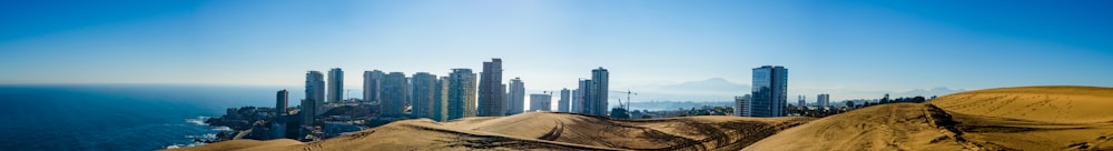 photography of high-rise buildings beside seashore during daytime