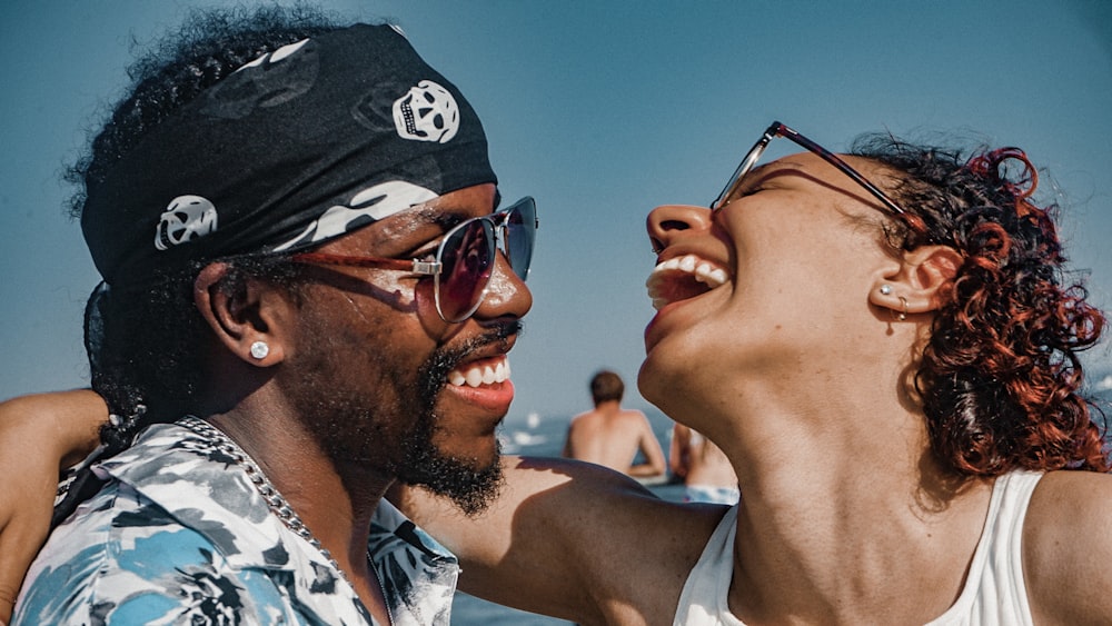 close-up photography of smiling man and woman near outdoor during daytime