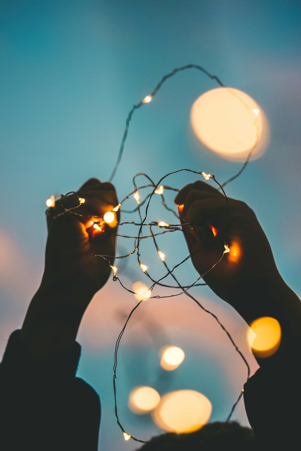 person holding string light