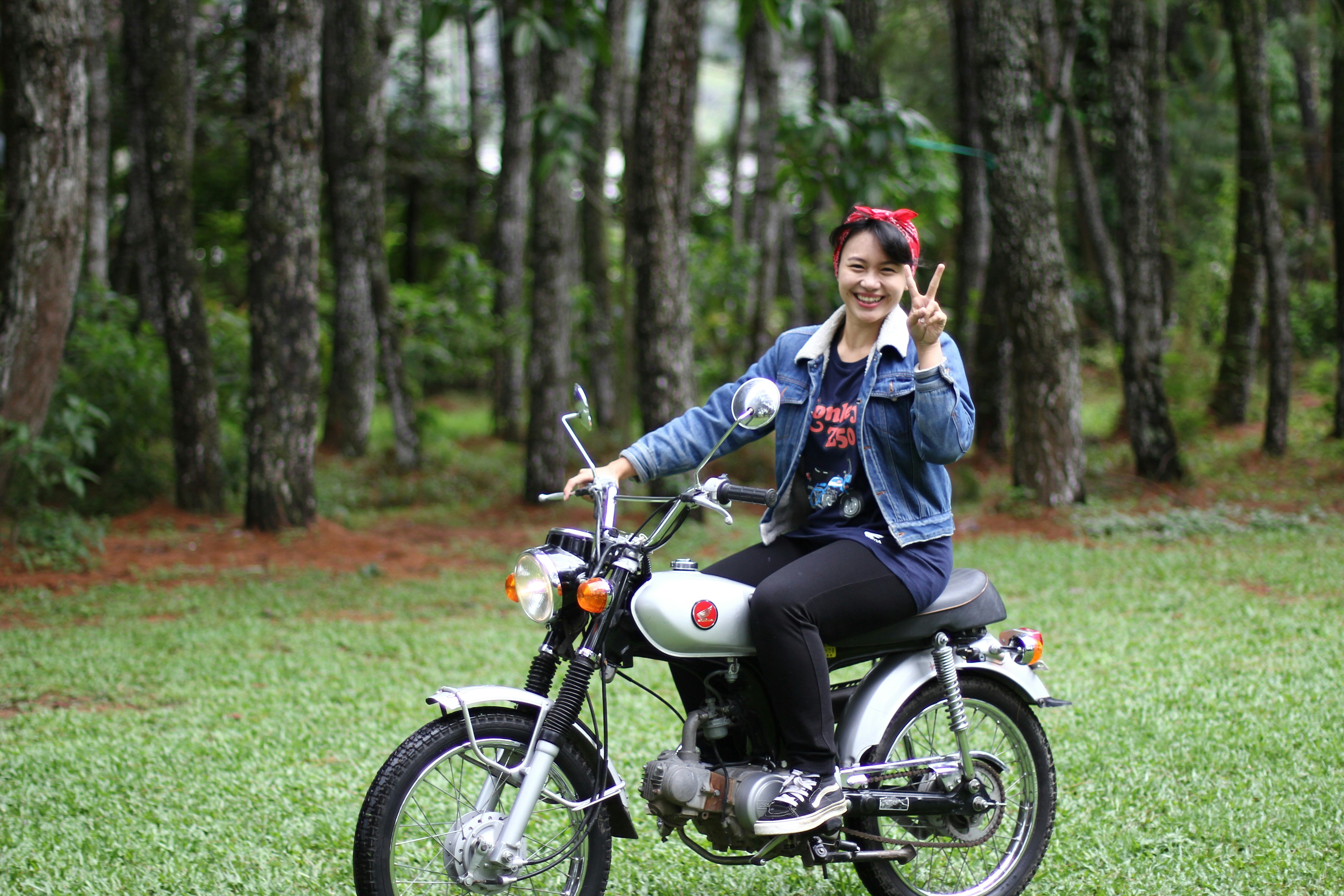 woman riding motorcycle in forest