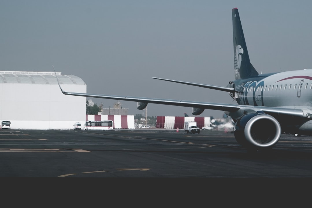 white and blue airliner on airport, wandering through the airport