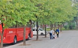 Driver assisting children boarding the bus with smiles