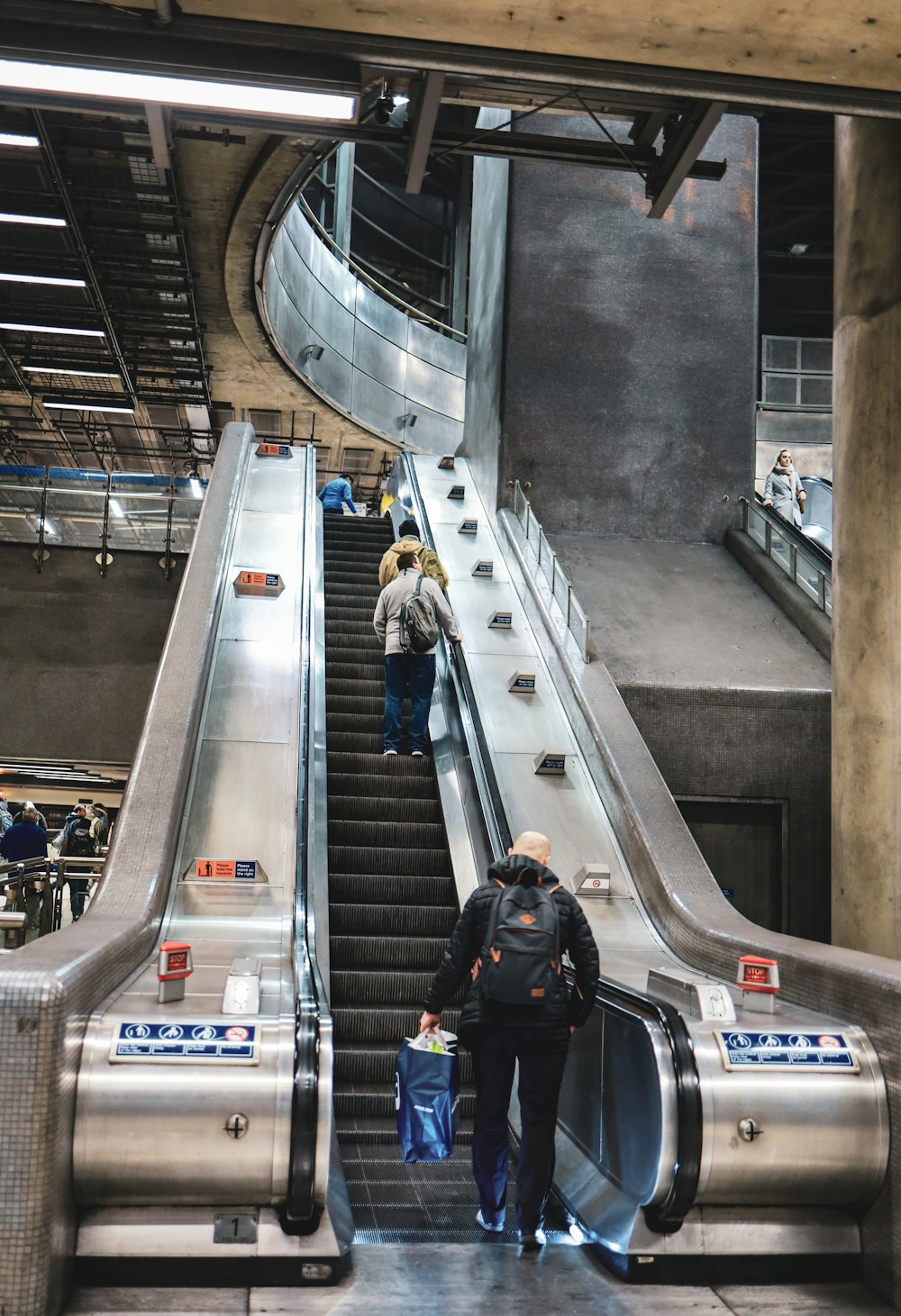 people riding on escalator