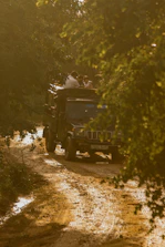 A rugged vehicle transporting hikers and gear to the Merbabu trailhead at dawn.
