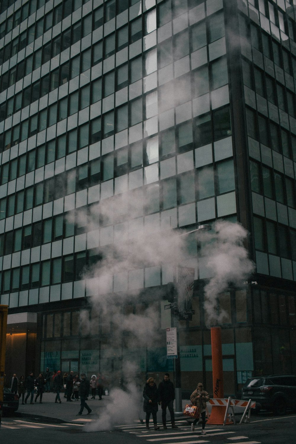 a group of people standing in front of a tall building