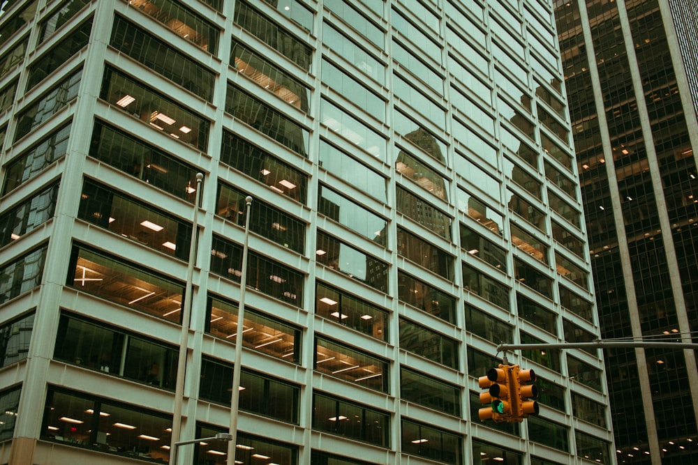 a traffic light hanging from the side of a tall building