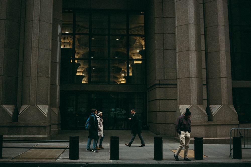 a group of people walking in front of a building